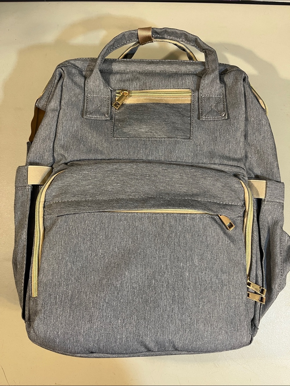 Stylish Gray Women's Backpack with Gold Hardware